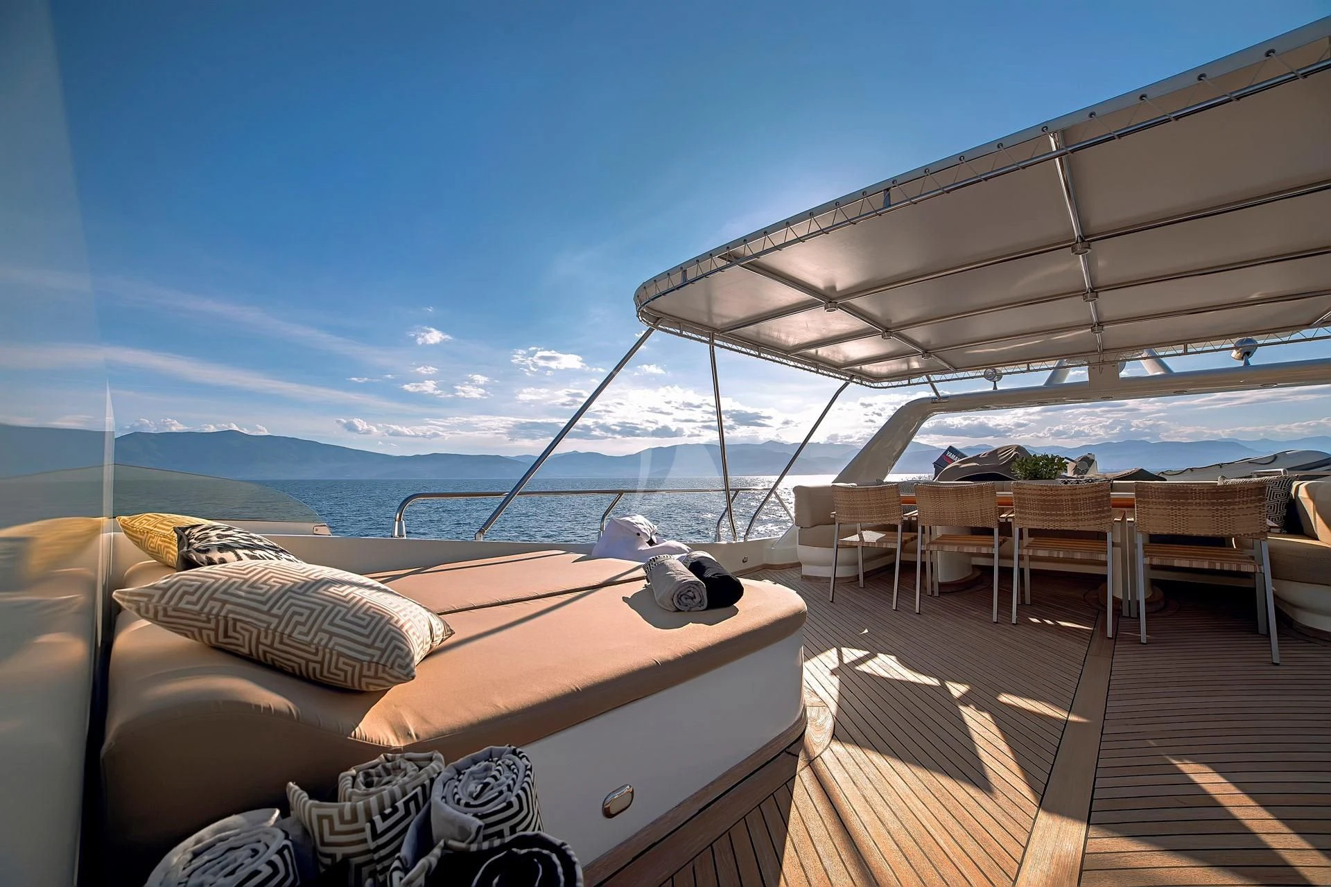 a deck with a large bed and a large body of water aboard AQUILA Yacht for Sale