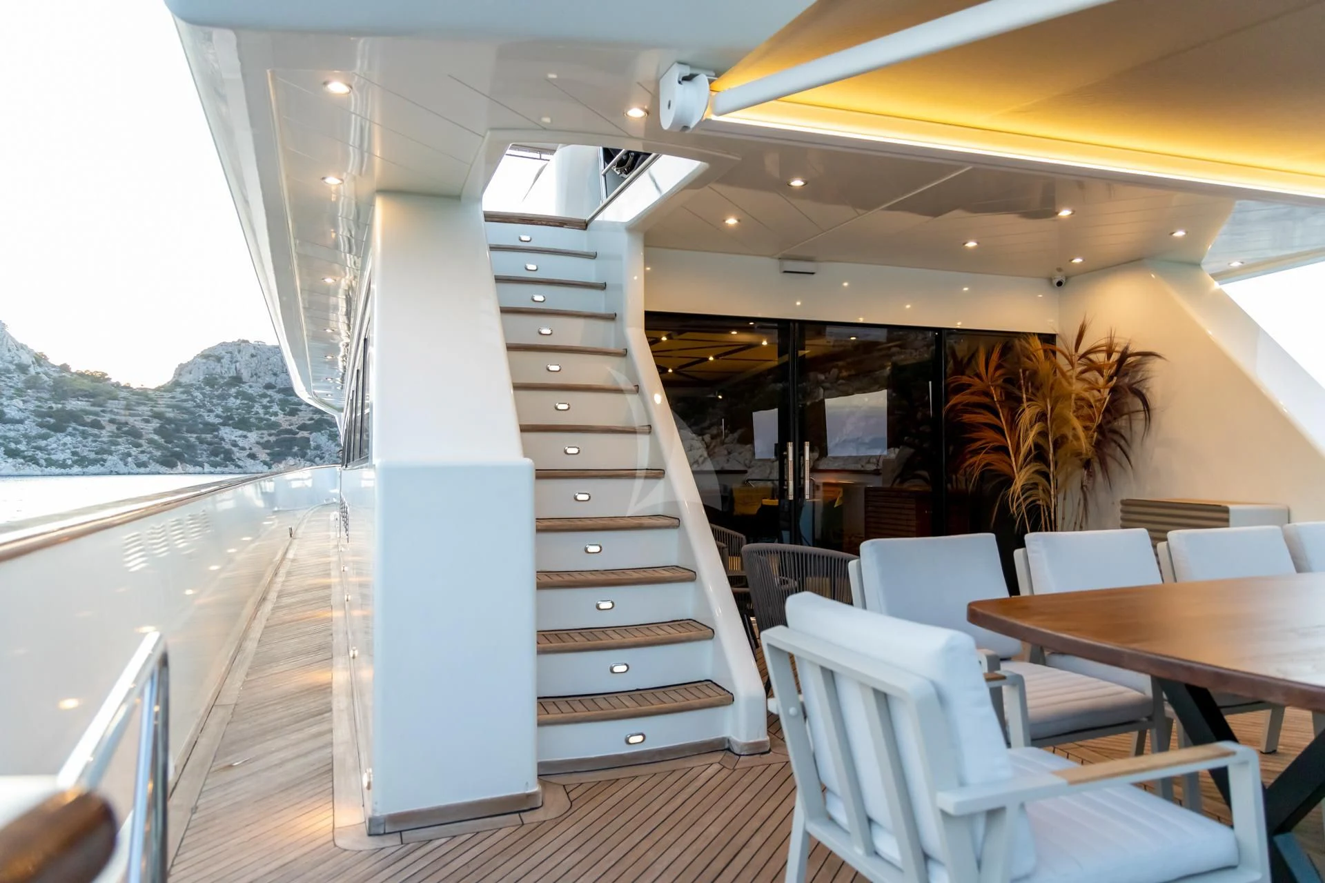 a boat with a staircase and chairs aboard AQUILA Yacht for Sale