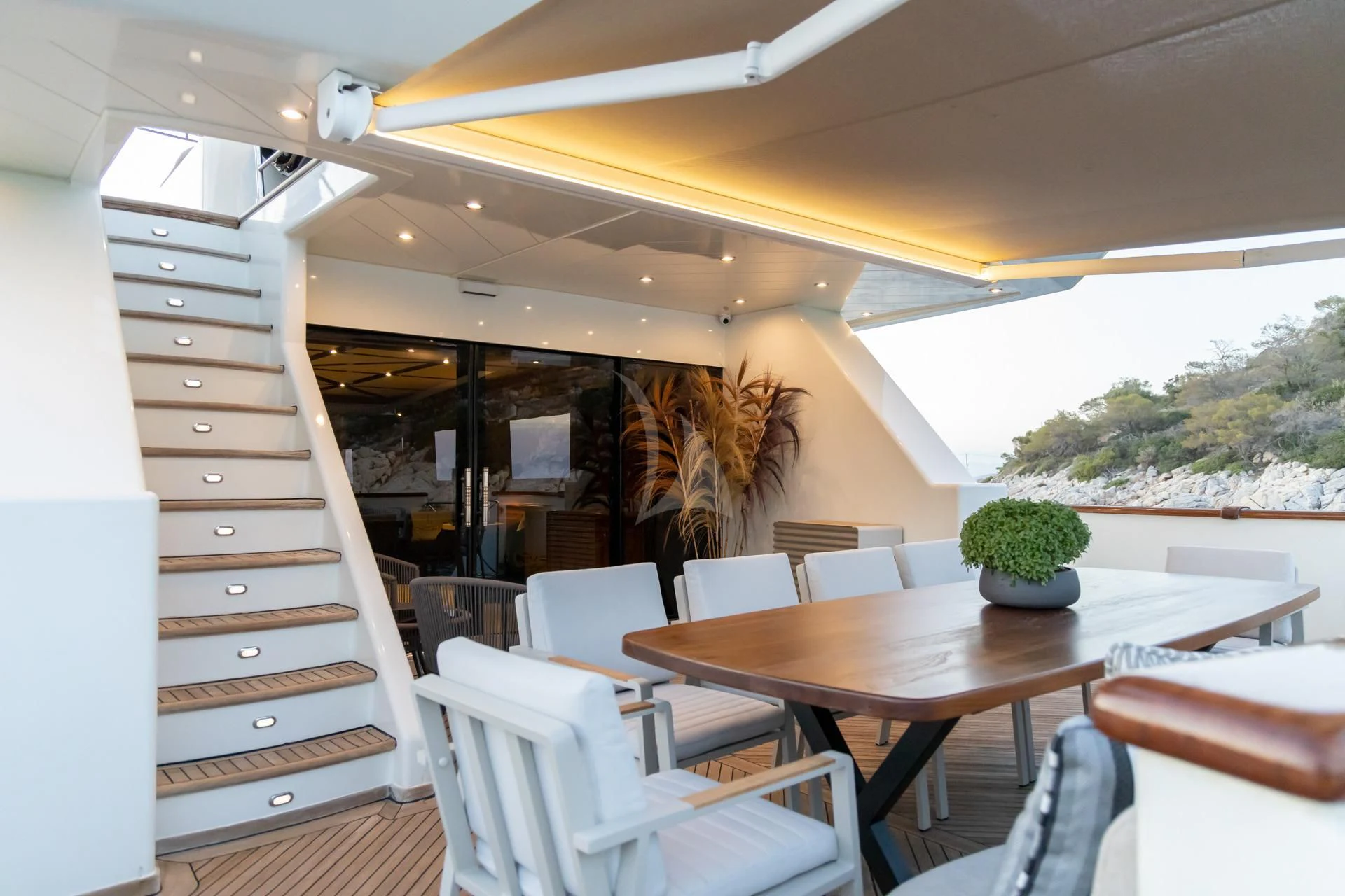 a room with a table and chairs aboard AQUILA Yacht for Sale