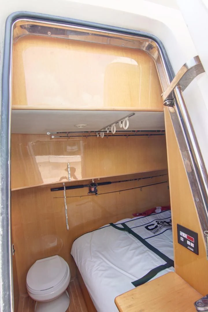 a small bunk bed in a wooden room aboard UNSINKABLE II Yacht for Sale