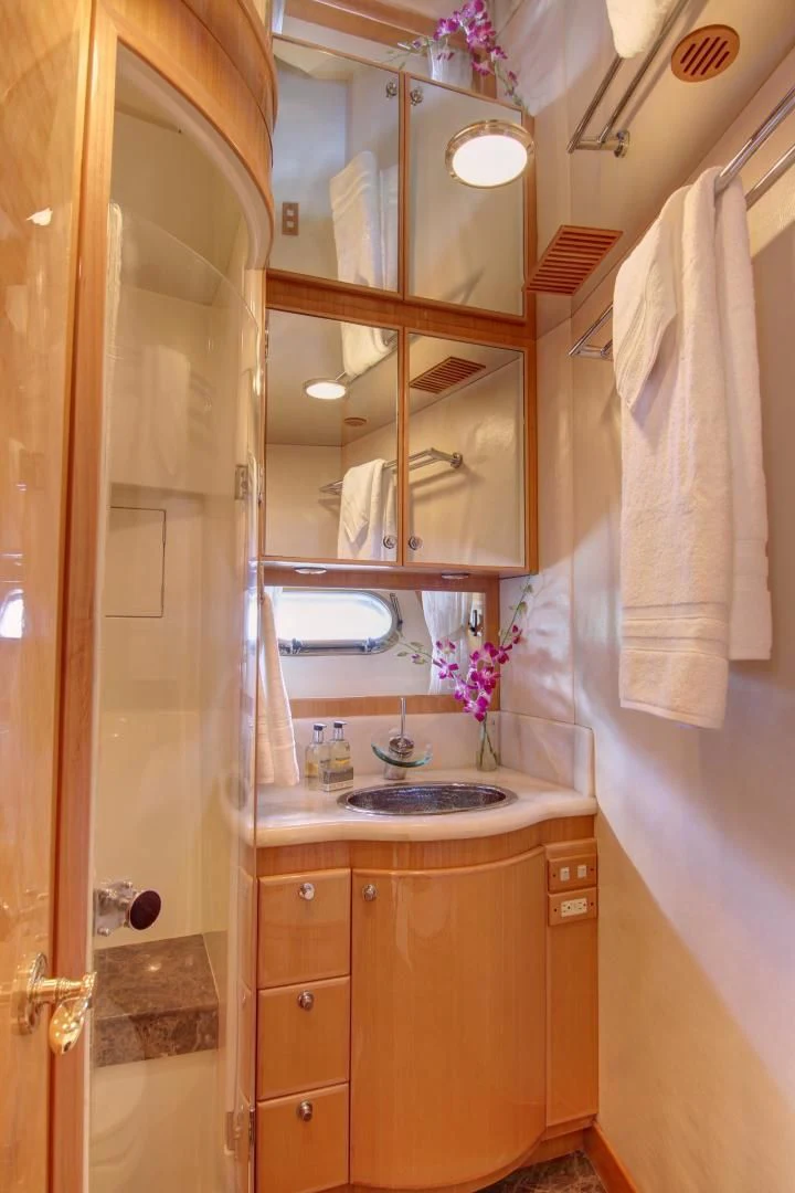a bathroom with a sink and a mirror aboard UNSINKABLE II Yacht for Sale