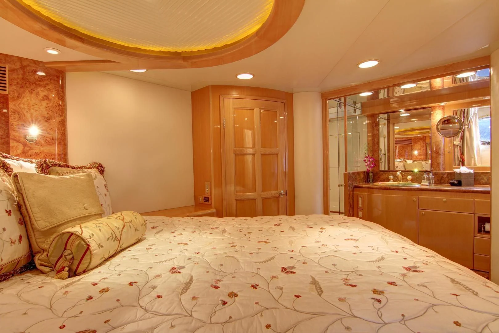 a bed with a white comforter aboard UNSINKABLE II Yacht for Sale