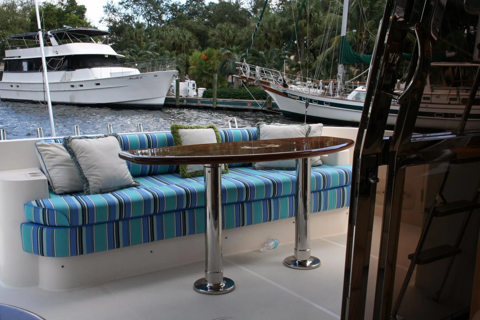 a couch on a table by a body of water aboard UNSINKABLE II Yacht for Sale