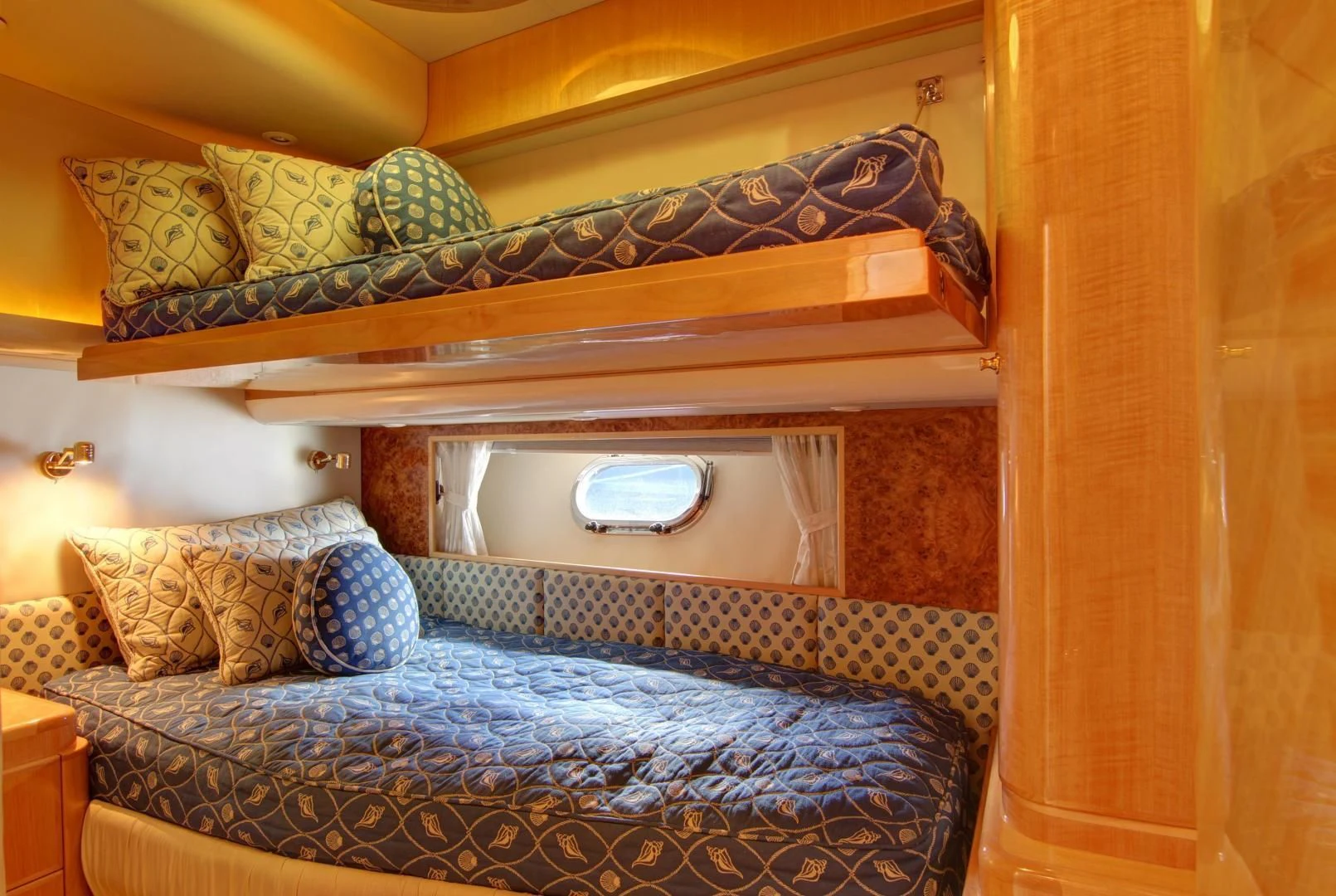 a bed with a blue blanket aboard UNSINKABLE II Yacht for Sale