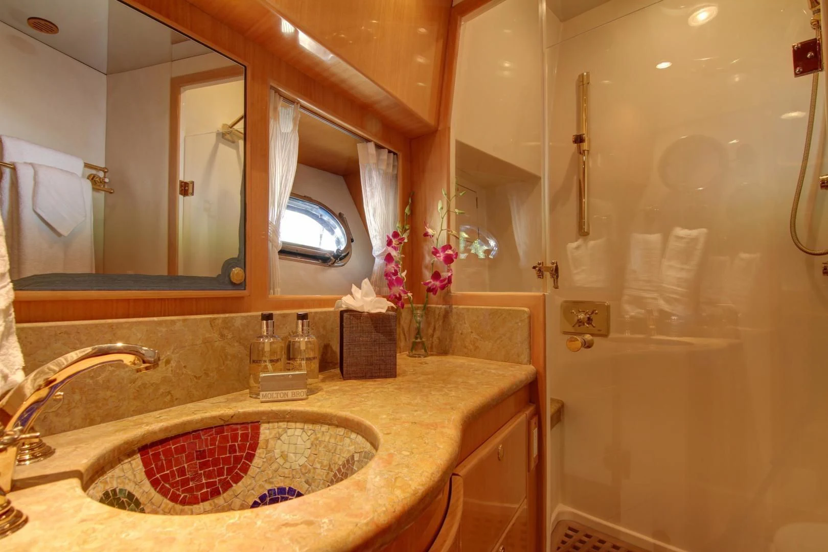 a bathroom with a sink and a mirror aboard UNSINKABLE II Yacht for Sale