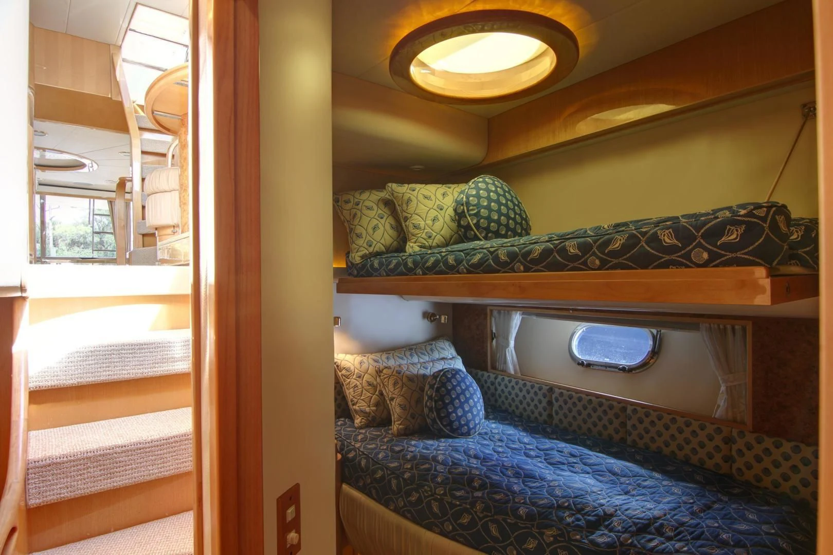 a bed with a blue blanket aboard UNSINKABLE II Yacht for Sale