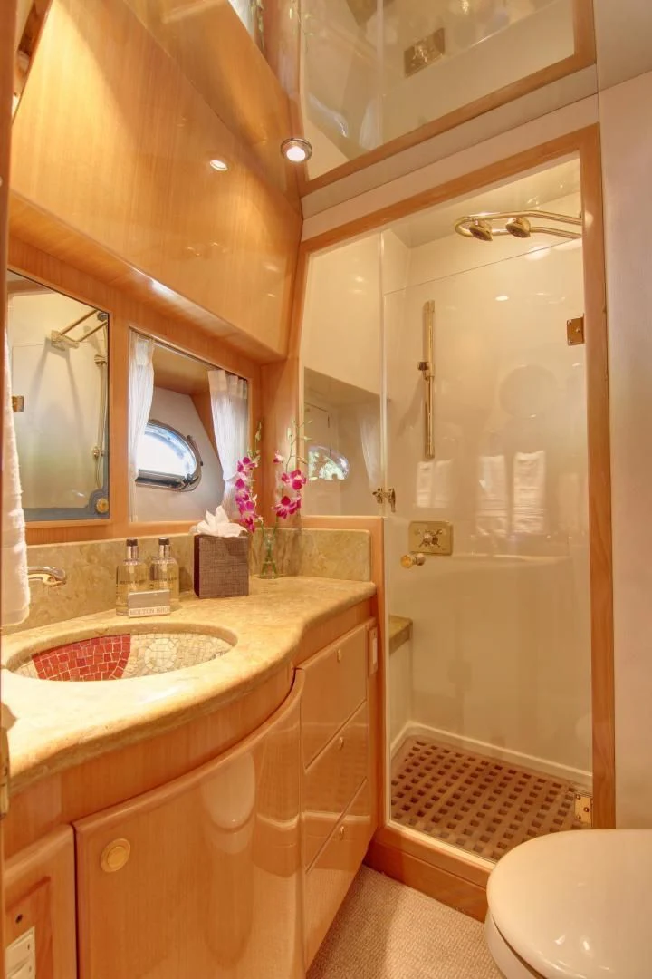 a bathroom with a glass shower door aboard UNSINKABLE II Yacht for Sale