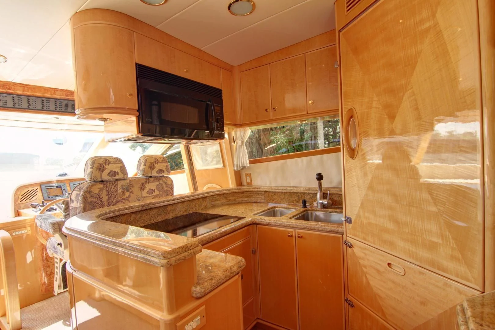 a kitchen with wooden cabinets aboard UNSINKABLE II Yacht for Sale