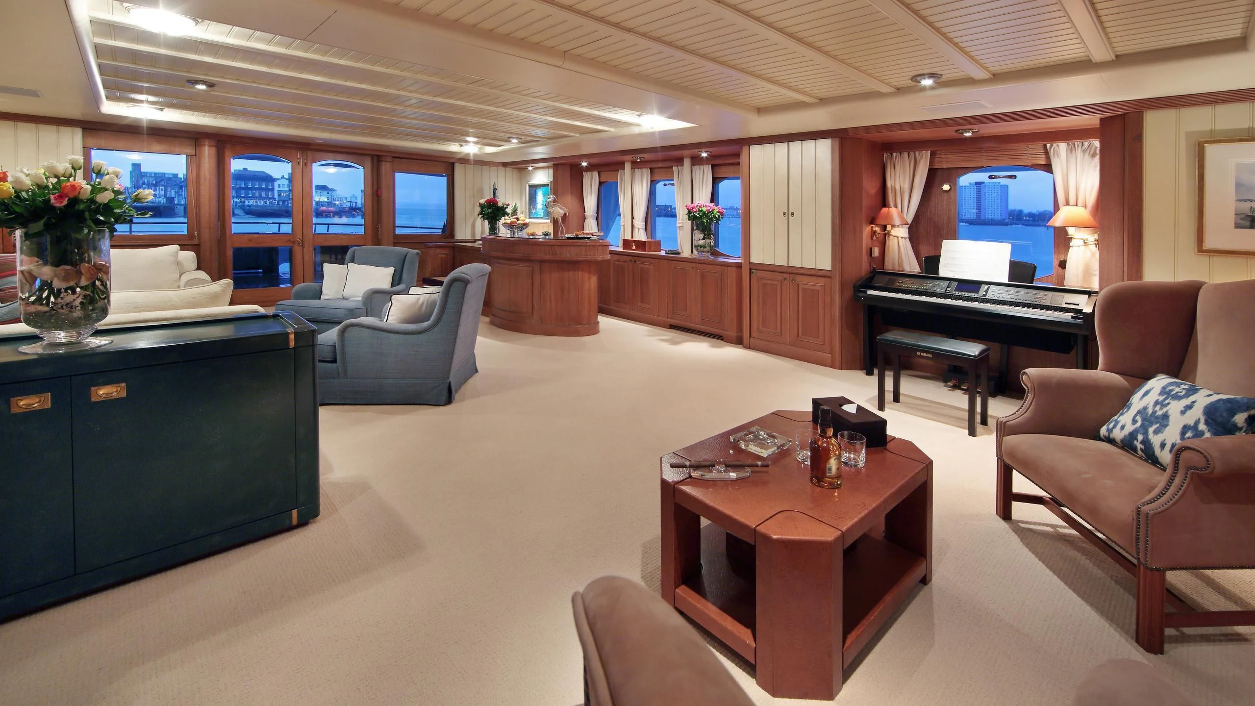 a living room with a piano and a piano aboard GLACIAL BEAR Yacht for Sale