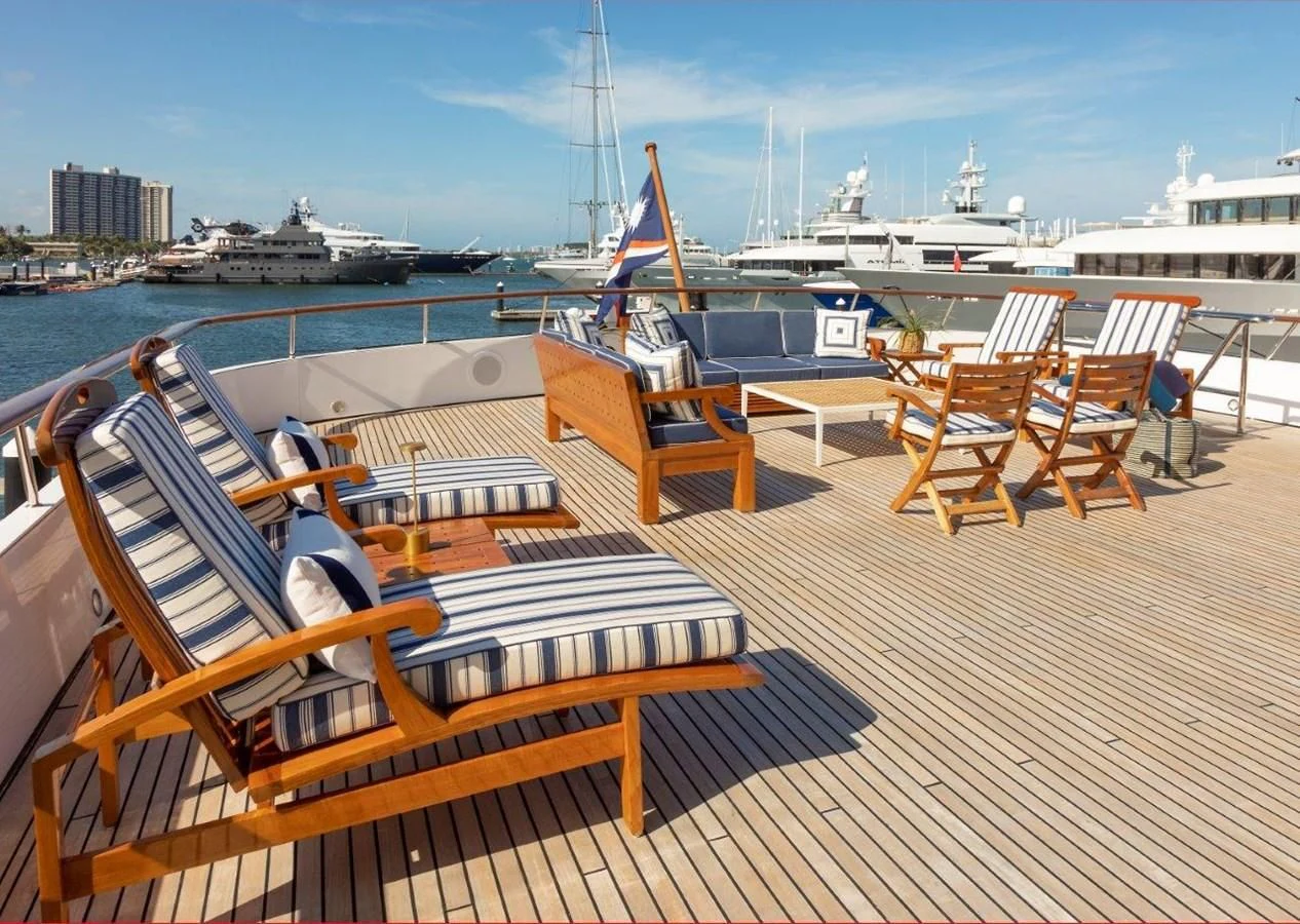 a deck with chairs and tables on it aboard GLACIAL BEAR Yacht for Sale