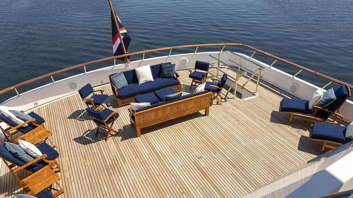 a deck with chairs and a boat on it aboard GLACIAL BEAR Yacht for Sale