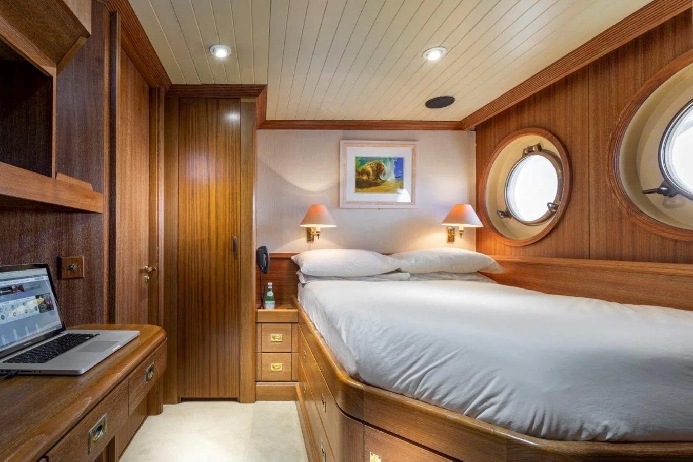 a bedroom with a laptop on the bed aboard GLACIAL BEAR Yacht for Sale