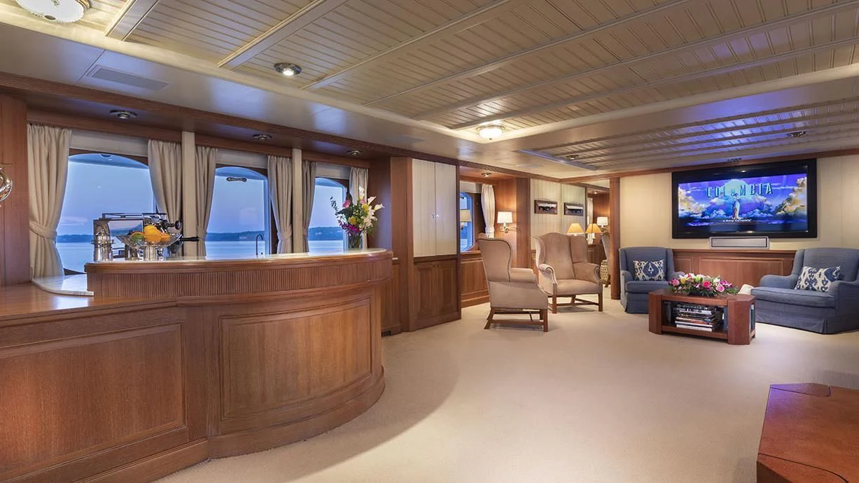 a room with a tv and couches aboard GLACIAL BEAR Yacht for Sale