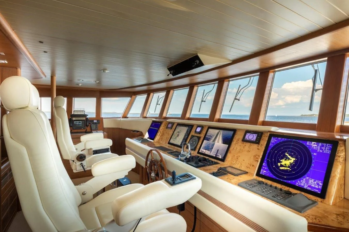 a room with a computer and a desk with chairs and computers aboard GLACIAL BEAR Yacht for Sale
