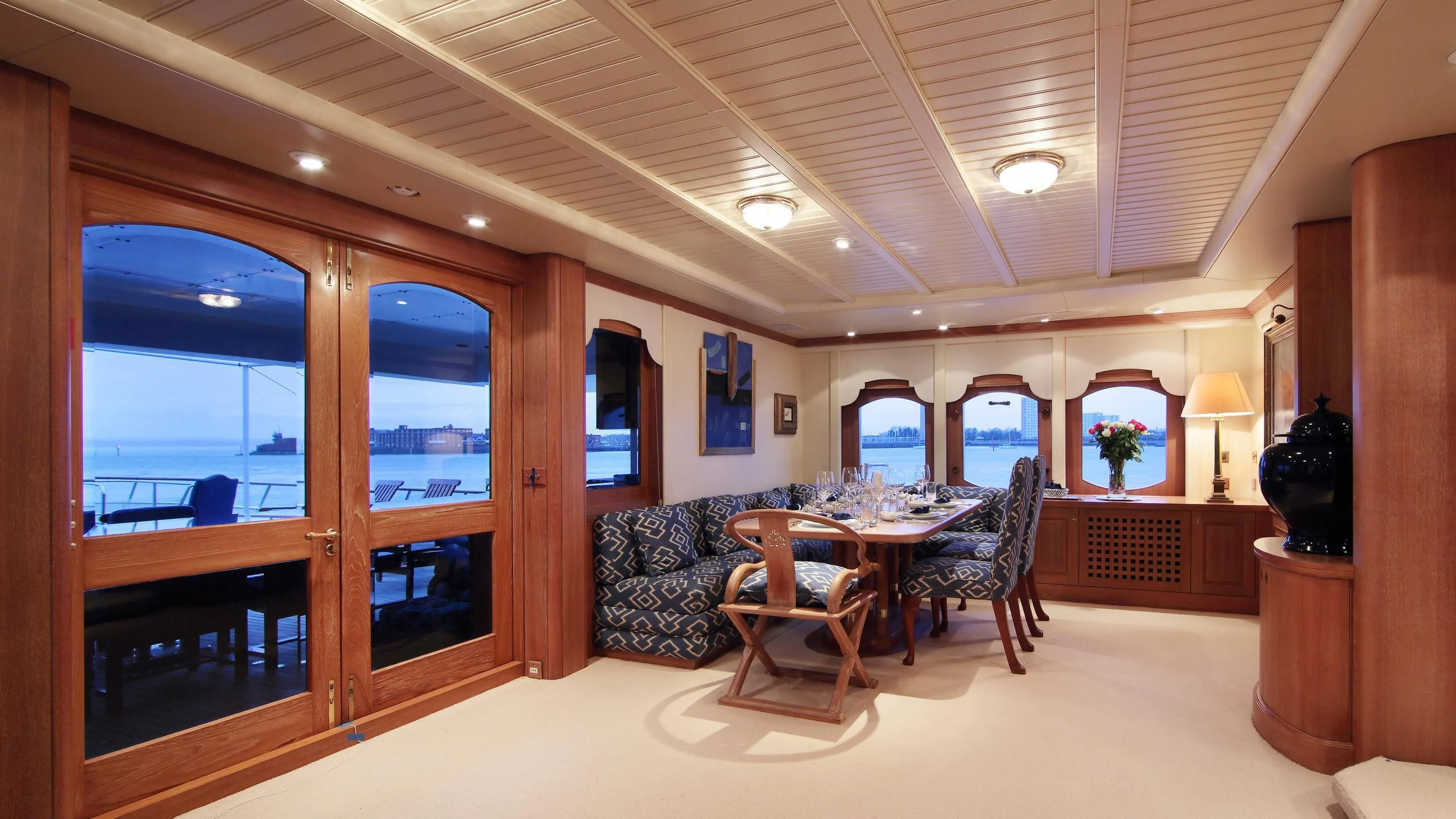 a living room with a table and chairs aboard GLACIAL BEAR Yacht for Sale