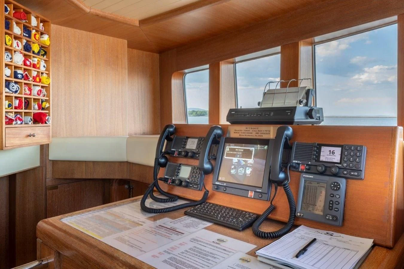 a desk with telephones and a laptop on it aboard GLACIAL BEAR Yacht for Sale