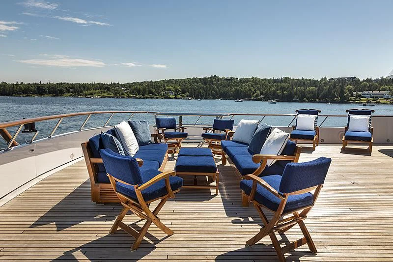 a group of chairs on a deck overlooking a body of water aboard GLACIAL BEAR Yacht for Sale