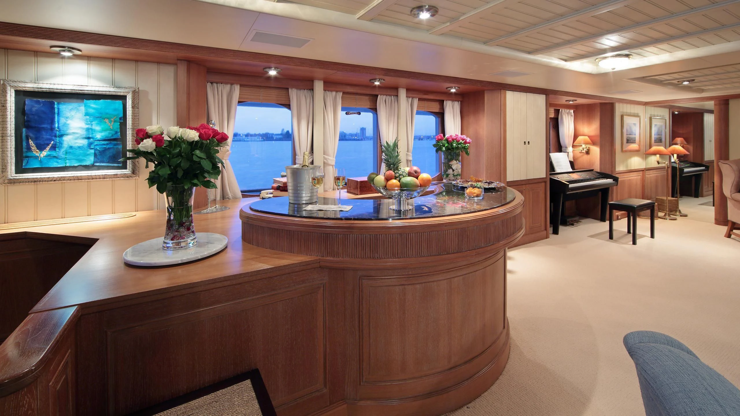 a large room with a table and chairs and a tv aboard GLACIAL BEAR Yacht for Sale