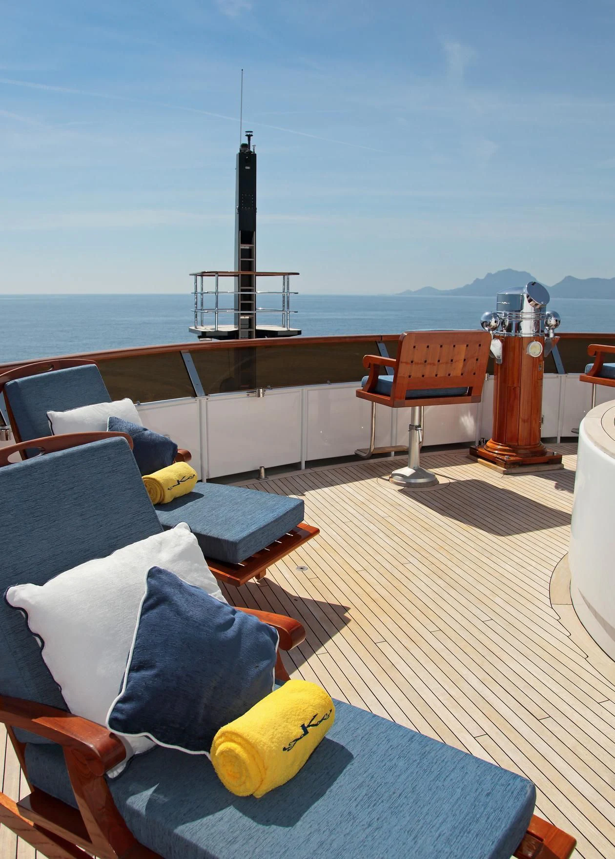 a room with a table chairs and a tower in the background aboard GLACIAL BEAR Yacht for Sale