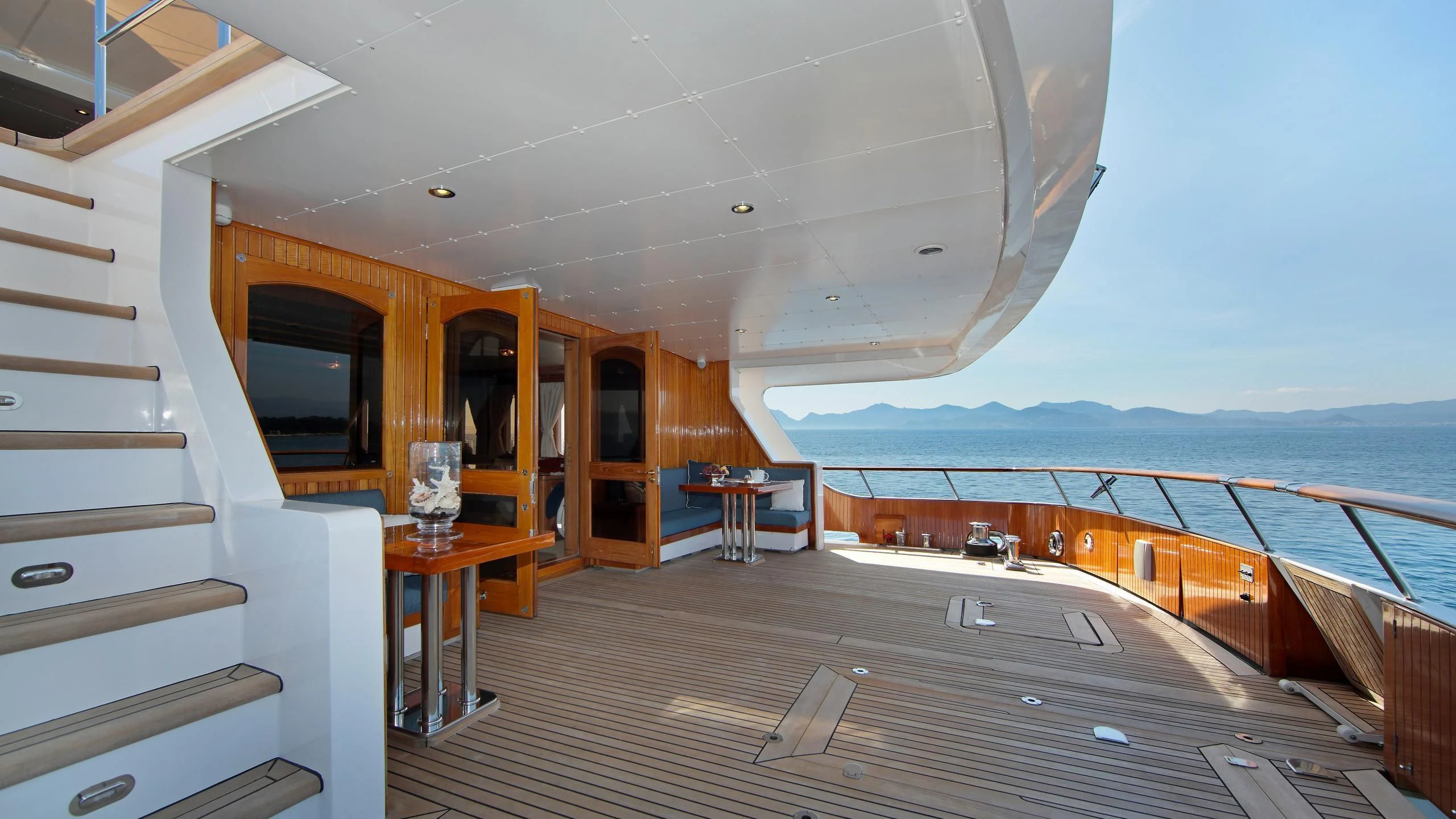 a wooden deck with a view of the ocean and the ocean aboard GLACIAL BEAR Yacht for Sale