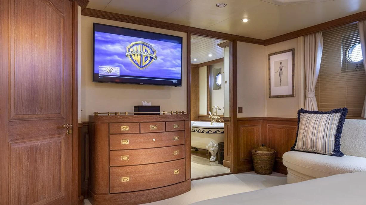 a room with a television and a dresser aboard GLACIAL BEAR Yacht for Sale