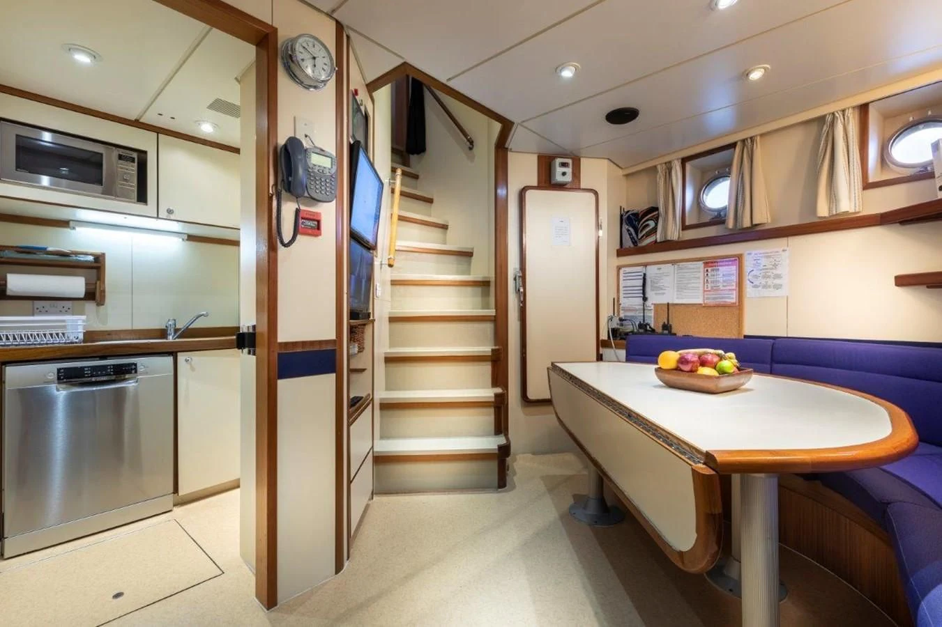 a kitchen with a table and a staircase aboard GLACIAL BEAR Yacht for Sale