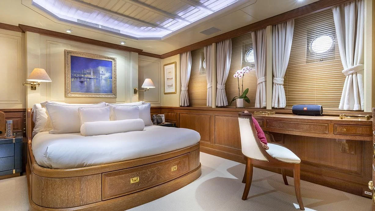a room with a bed and a desk aboard GLACIAL BEAR Yacht for Sale
