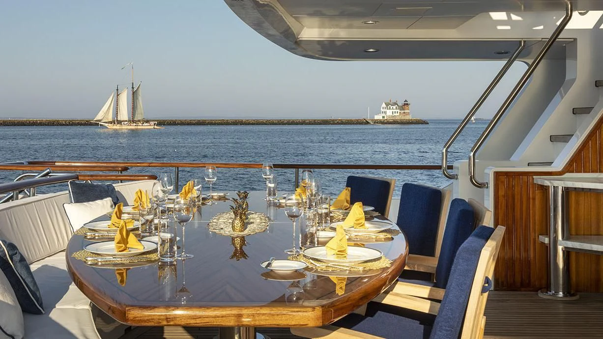 a table with glasses and plates on it aboard GLACIAL BEAR Yacht for Sale