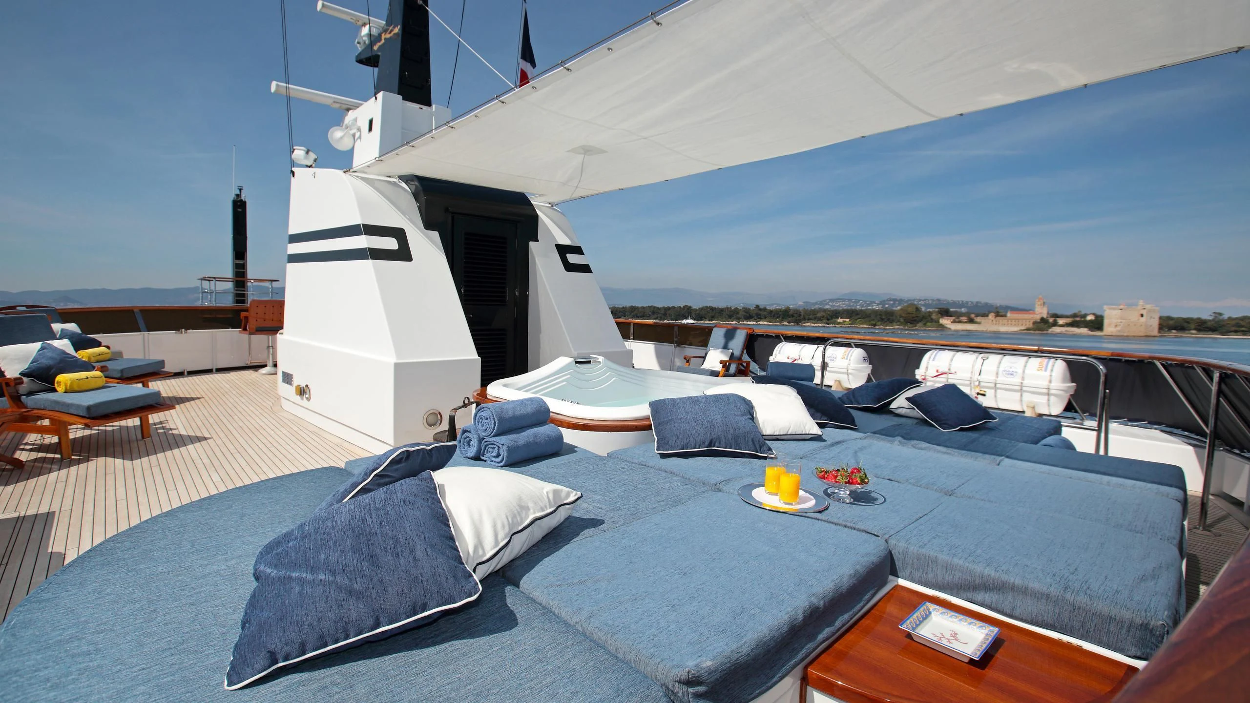 a large white tent with a blue bed and a blue couch aboard GLACIAL BEAR Yacht for Sale