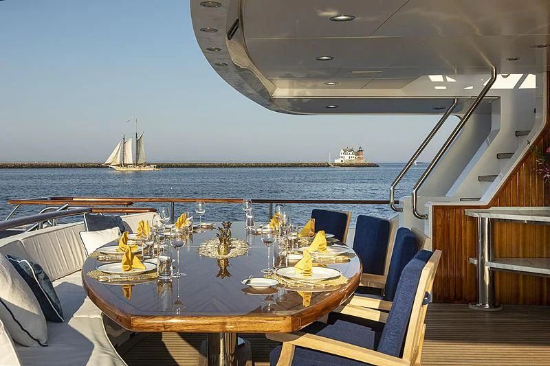 a table with chairs and a view of the water aboard GLACIAL BEAR Yacht for Sale