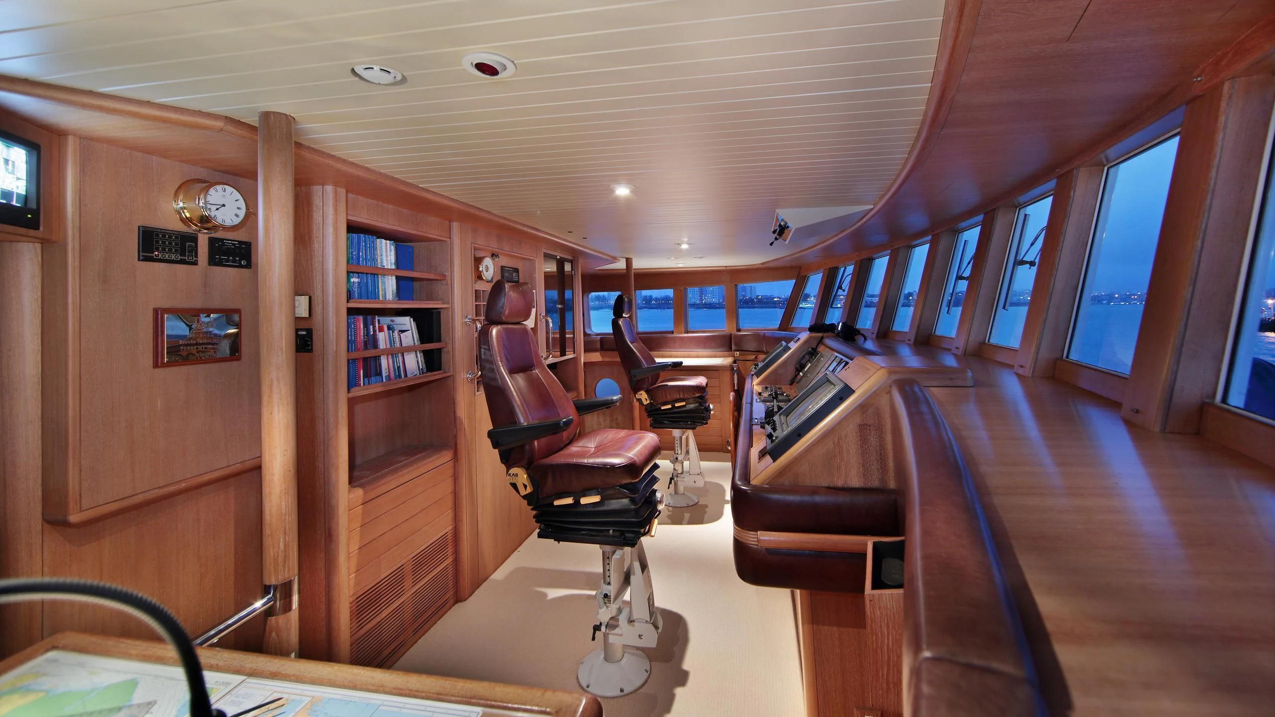 a room with a wood desk and chairs and a bookcase aboard GLACIAL BEAR Yacht for Sale