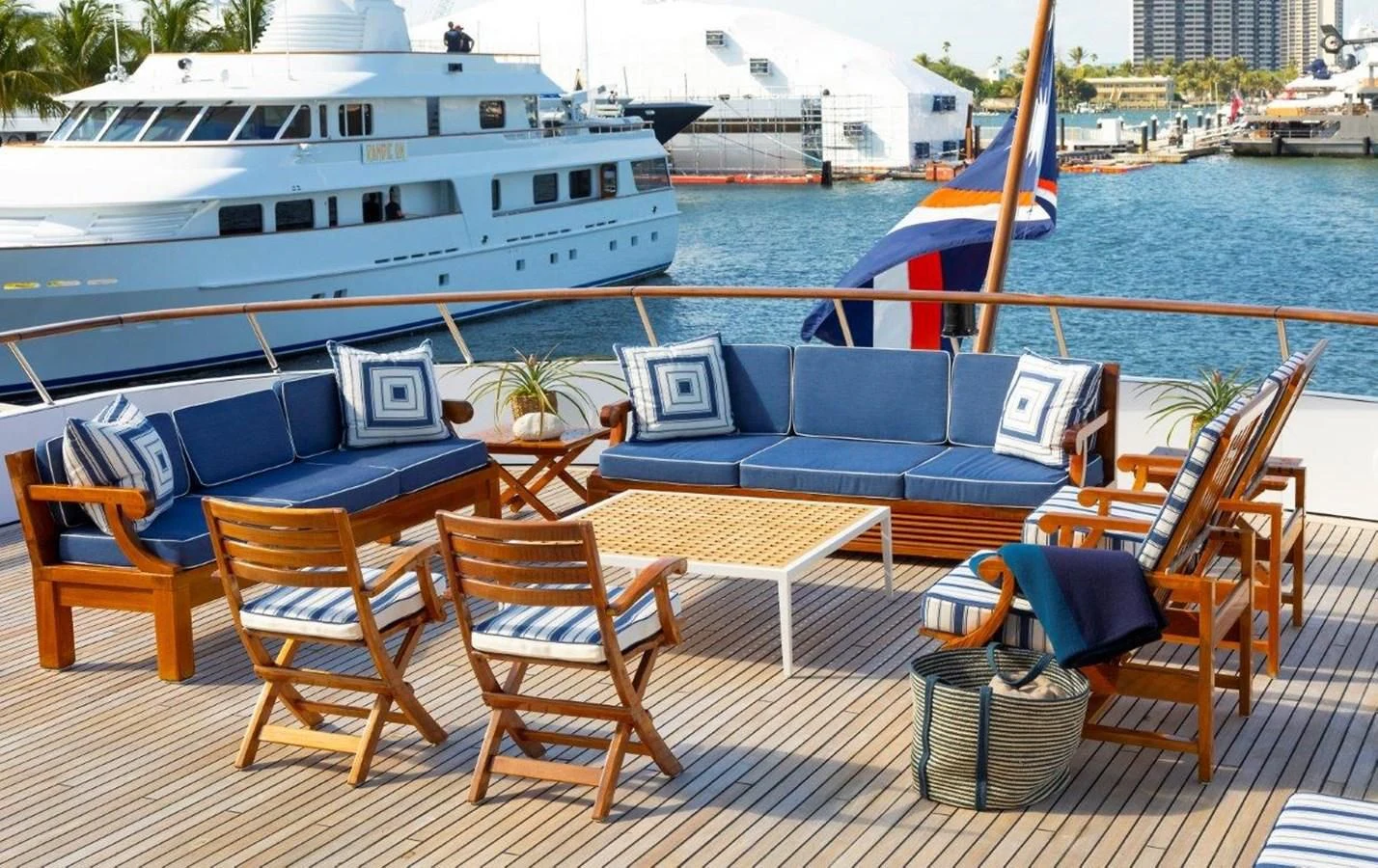 a deck with chairs and tables on it by a body of water aboard GLACIAL BEAR Yacht for Sale