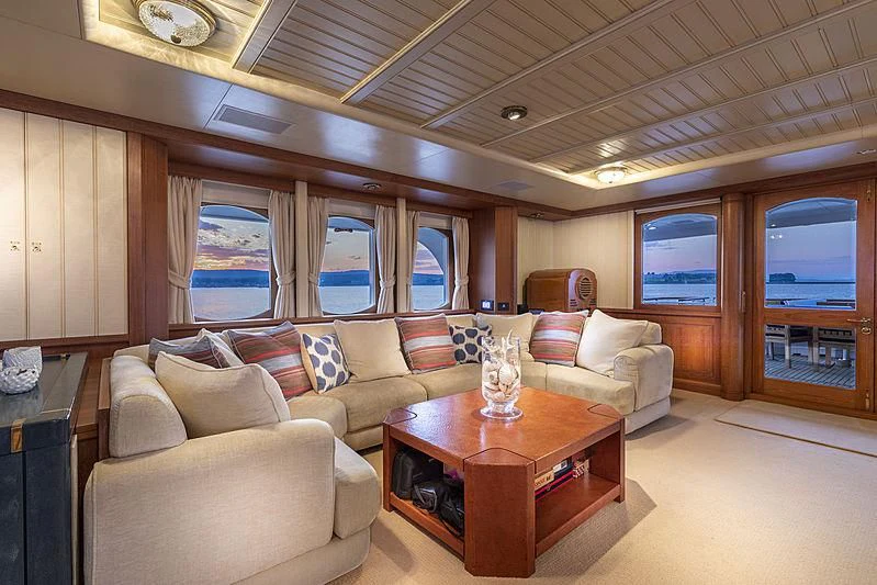 a living room with a couch and a table aboard GLACIAL BEAR Yacht for Sale