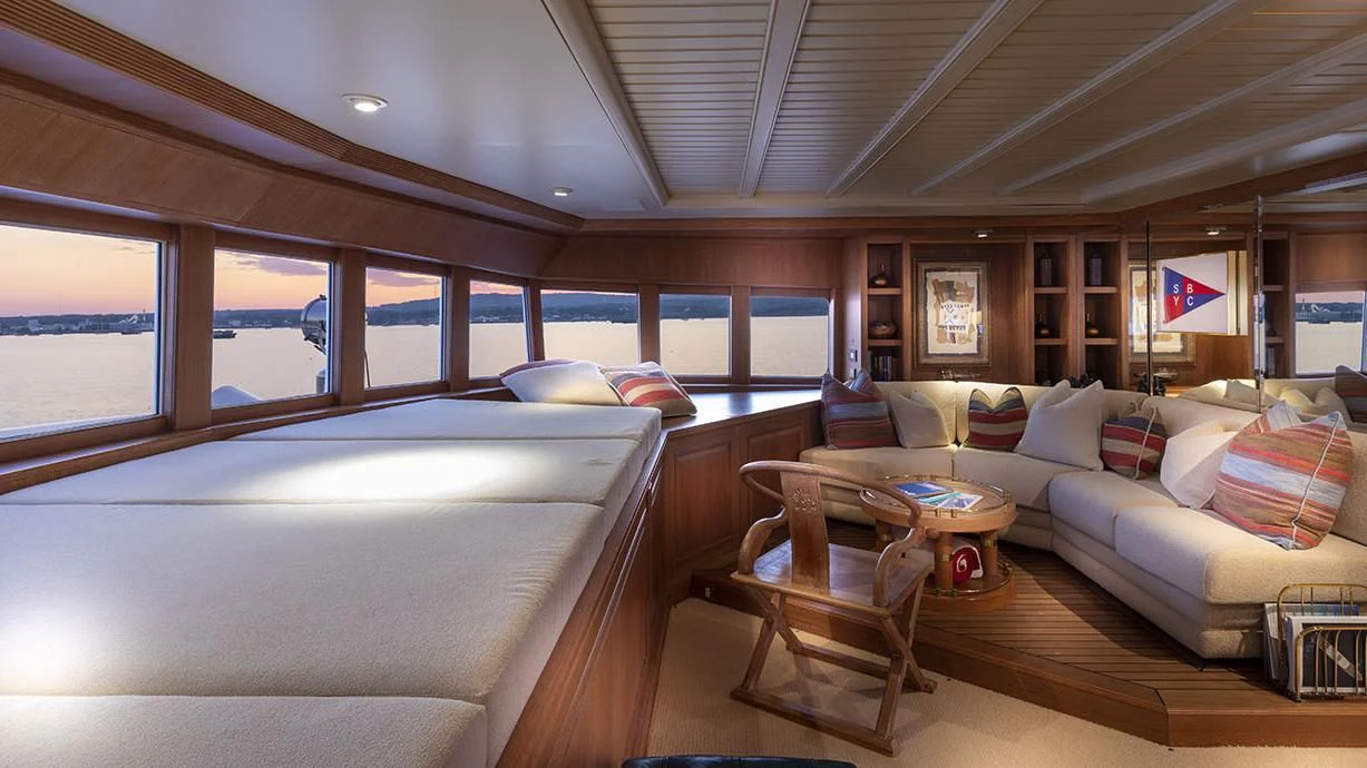a living room with a couch and a table aboard GLACIAL BEAR Yacht for Sale