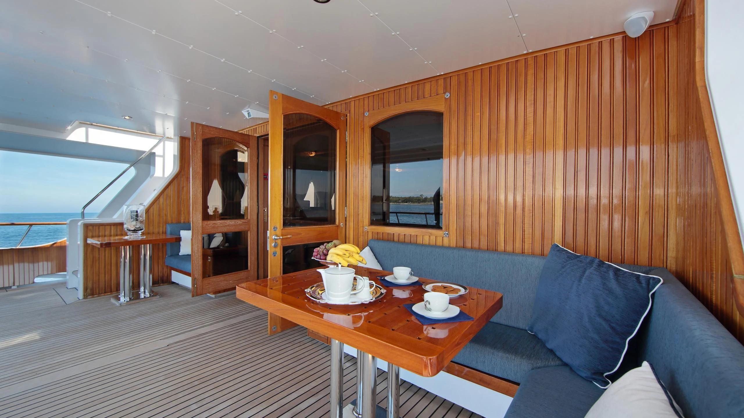 a room with a couch and a table aboard GLACIAL BEAR Yacht for Sale