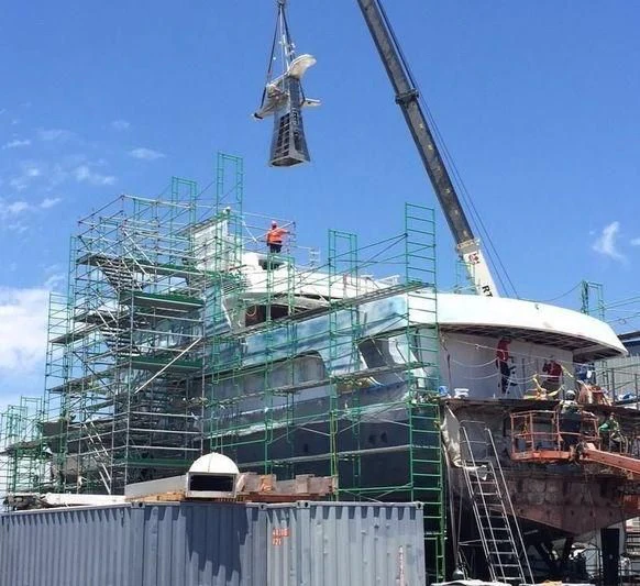 a large blue crane with a few people on it aboard GLACIAL BEAR Yacht for Sale