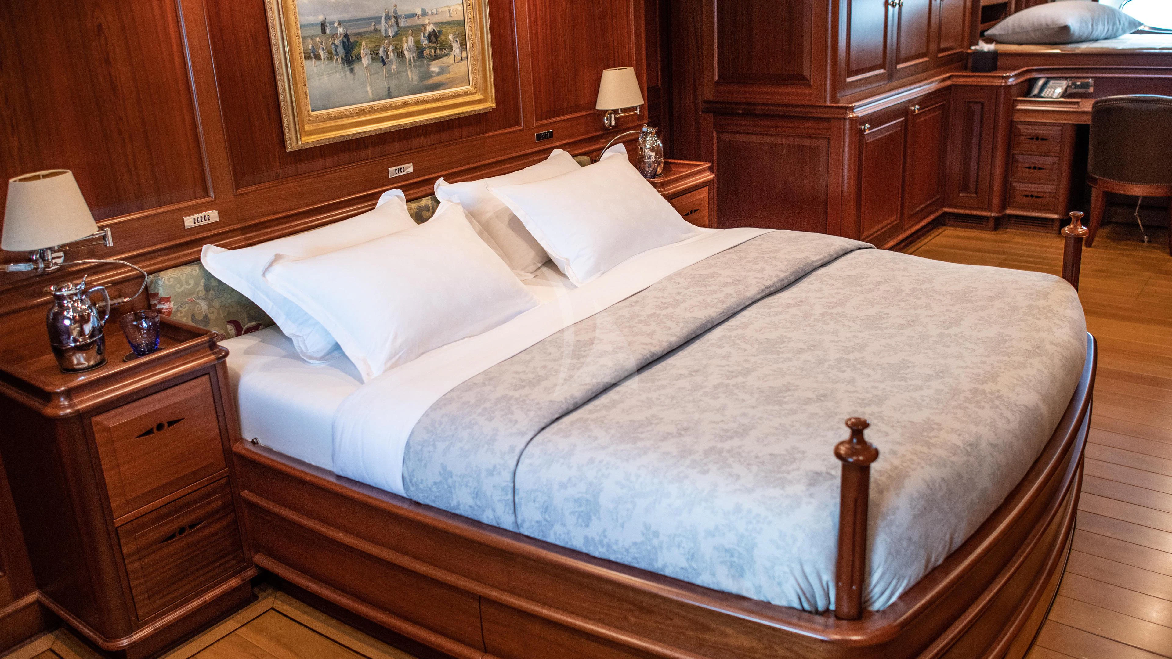 a bed with white sheets aboard ATHOS Yacht for Sale