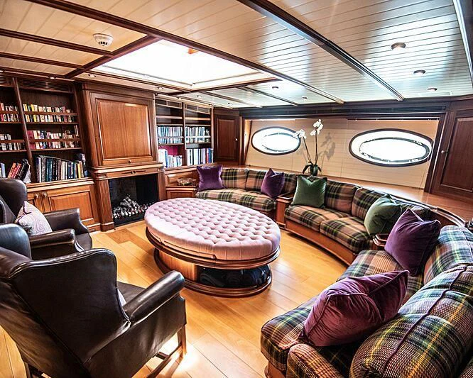 a living room with a couch and a table aboard ATHOS Yacht for Sale
