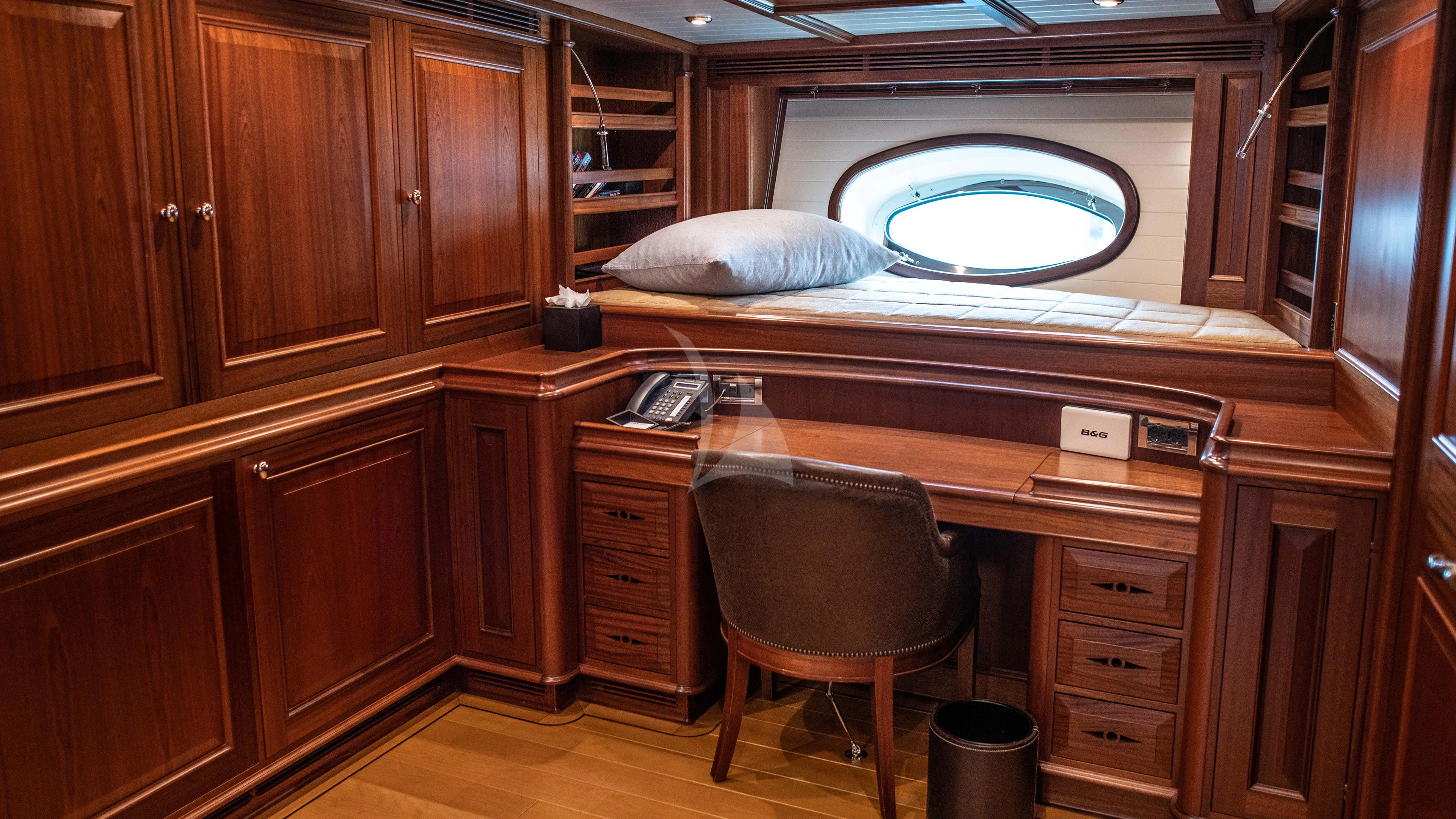 a room with a desk and a chair aboard ATHOS Yacht for Sale