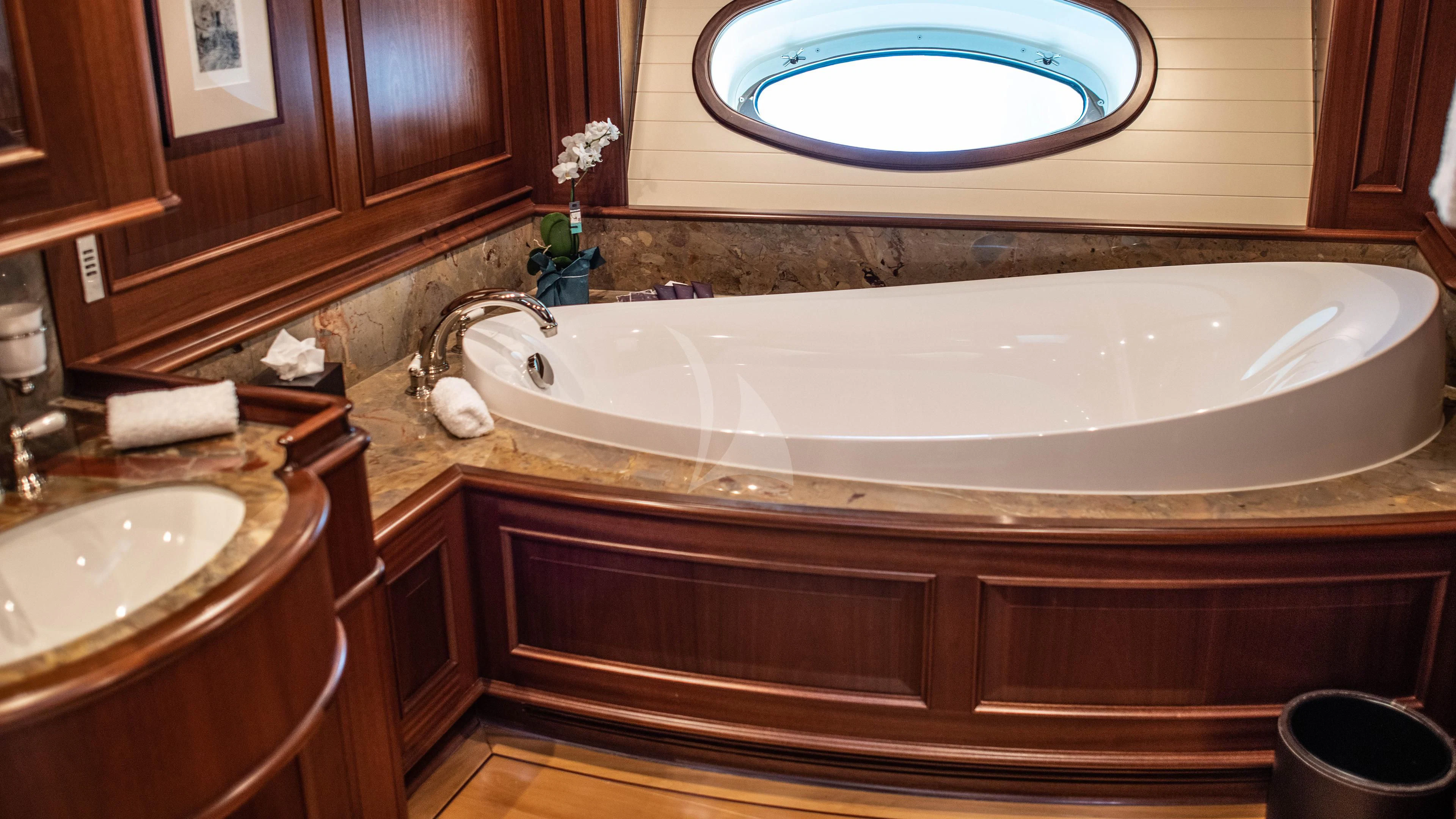 a bathroom with a large bathtub aboard ATHOS Yacht for Sale