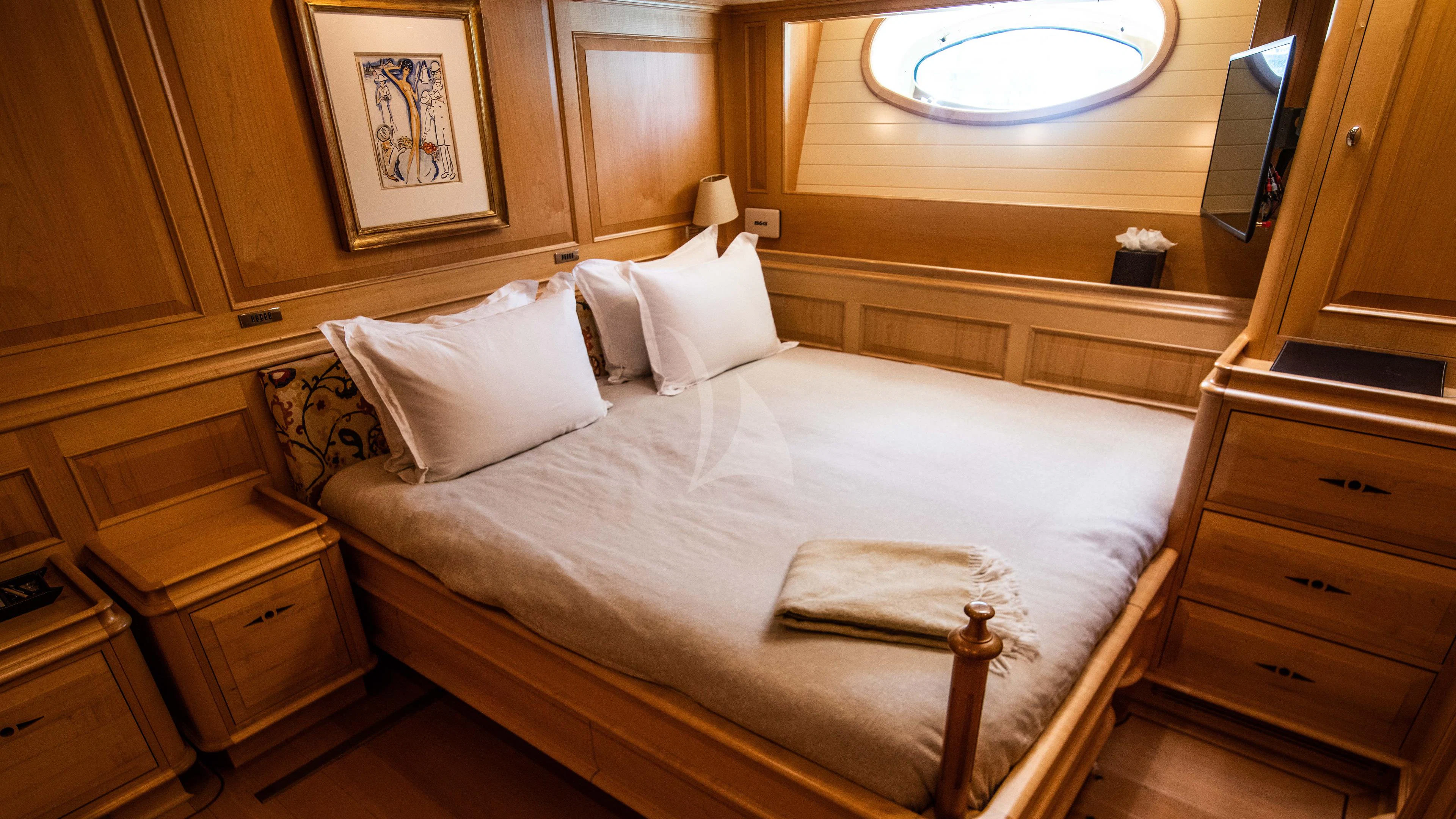 a bed with white sheets aboard ATHOS Yacht for Sale