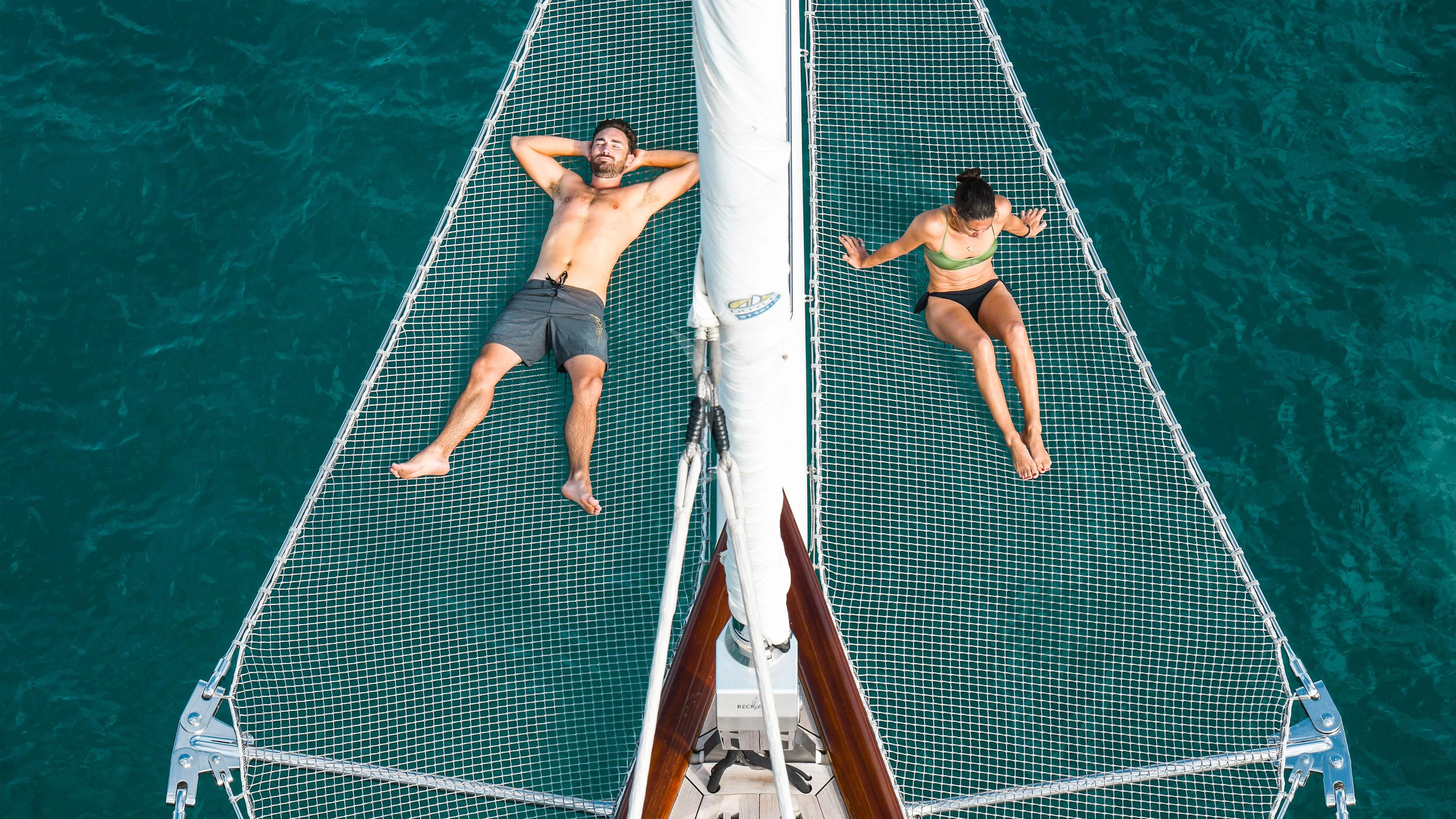 a woman jumping on a tennis court aboard ATHOS Yacht for Sale