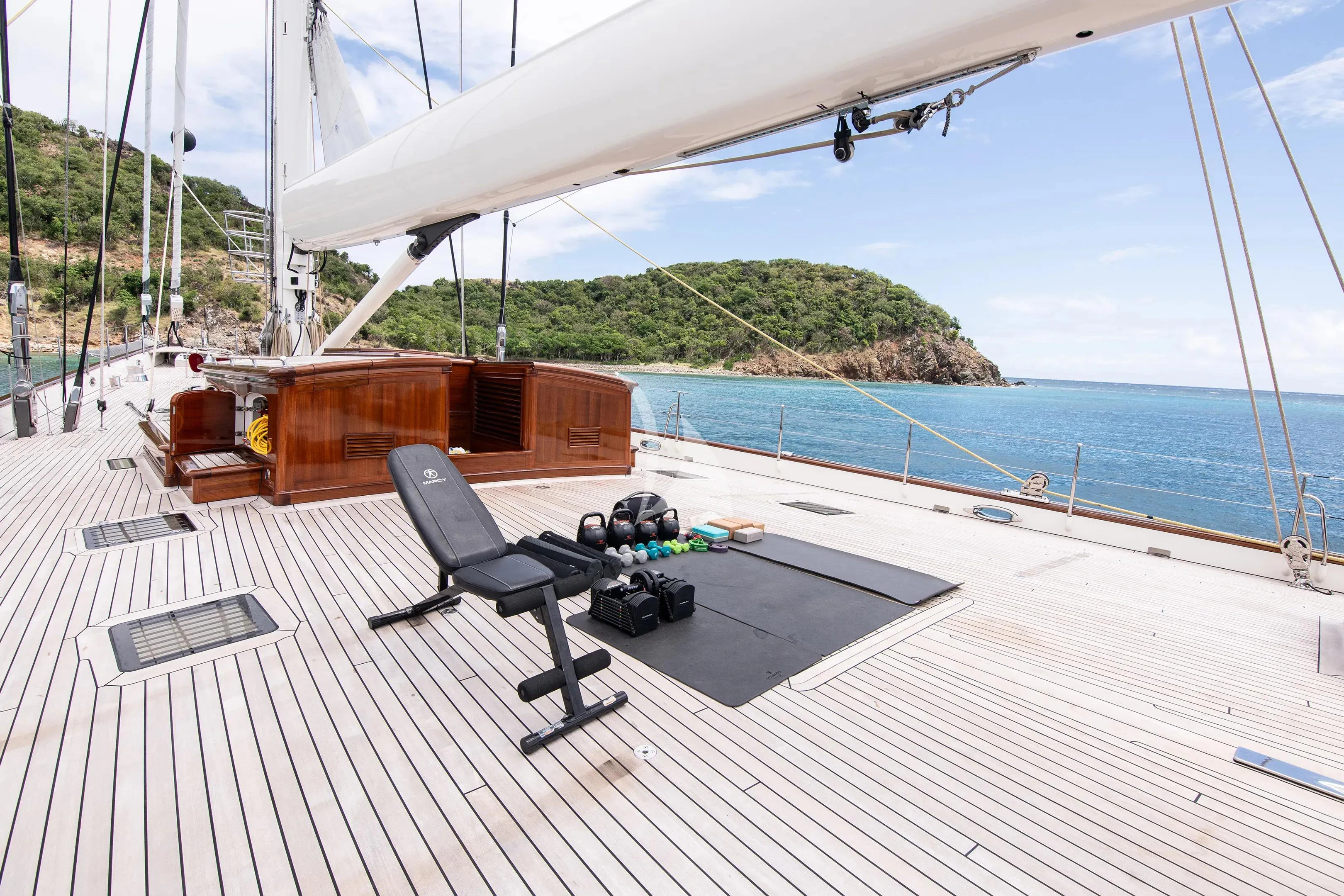 a deck with a chair and a table on it aboard ATHOS Yacht for Sale