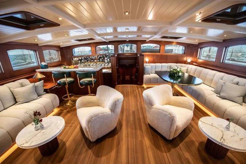 a room with couches and tables aboard ATHOS Yacht for Sale