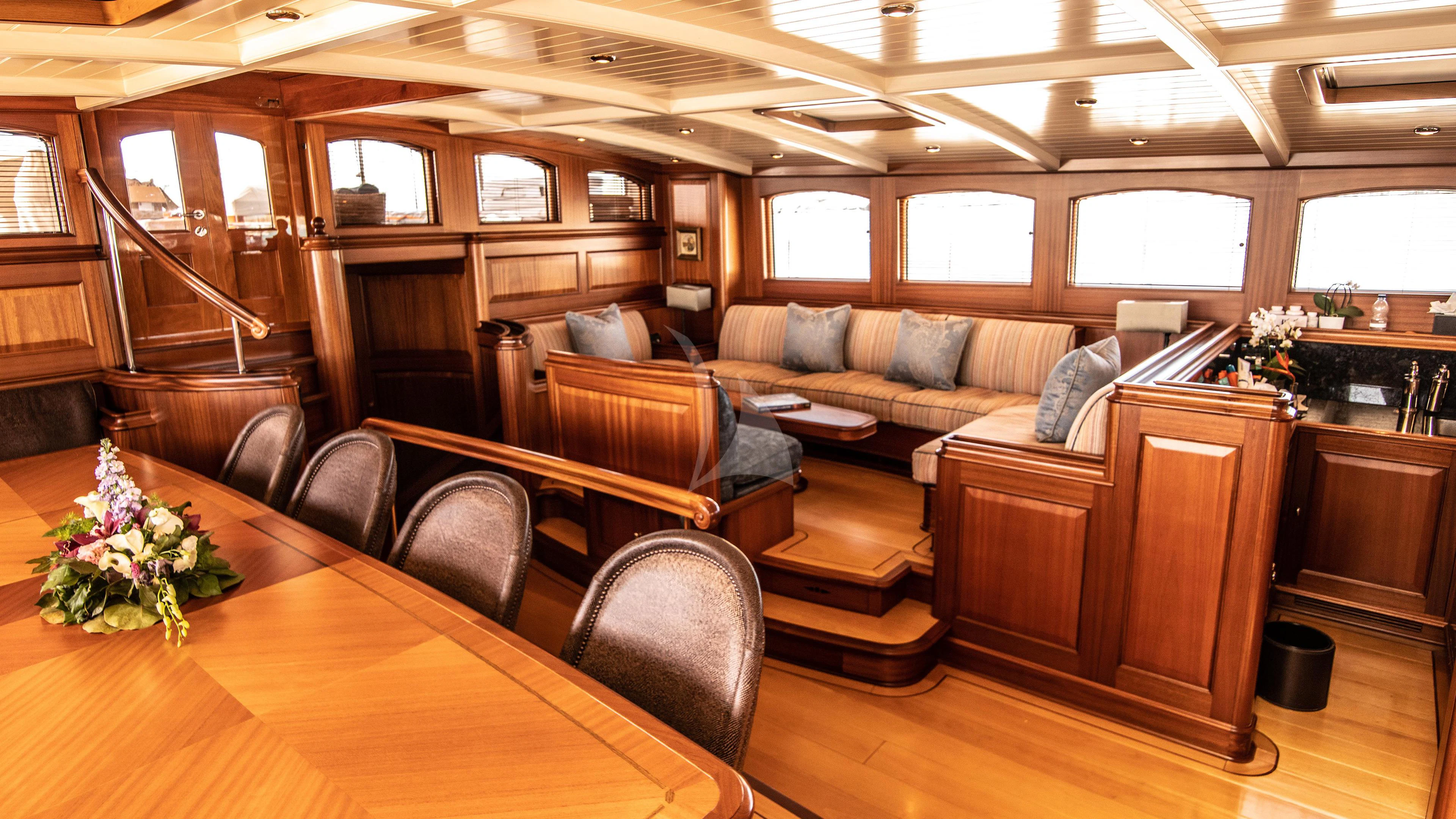 a living room with leather couches aboard ATHOS Yacht for Sale