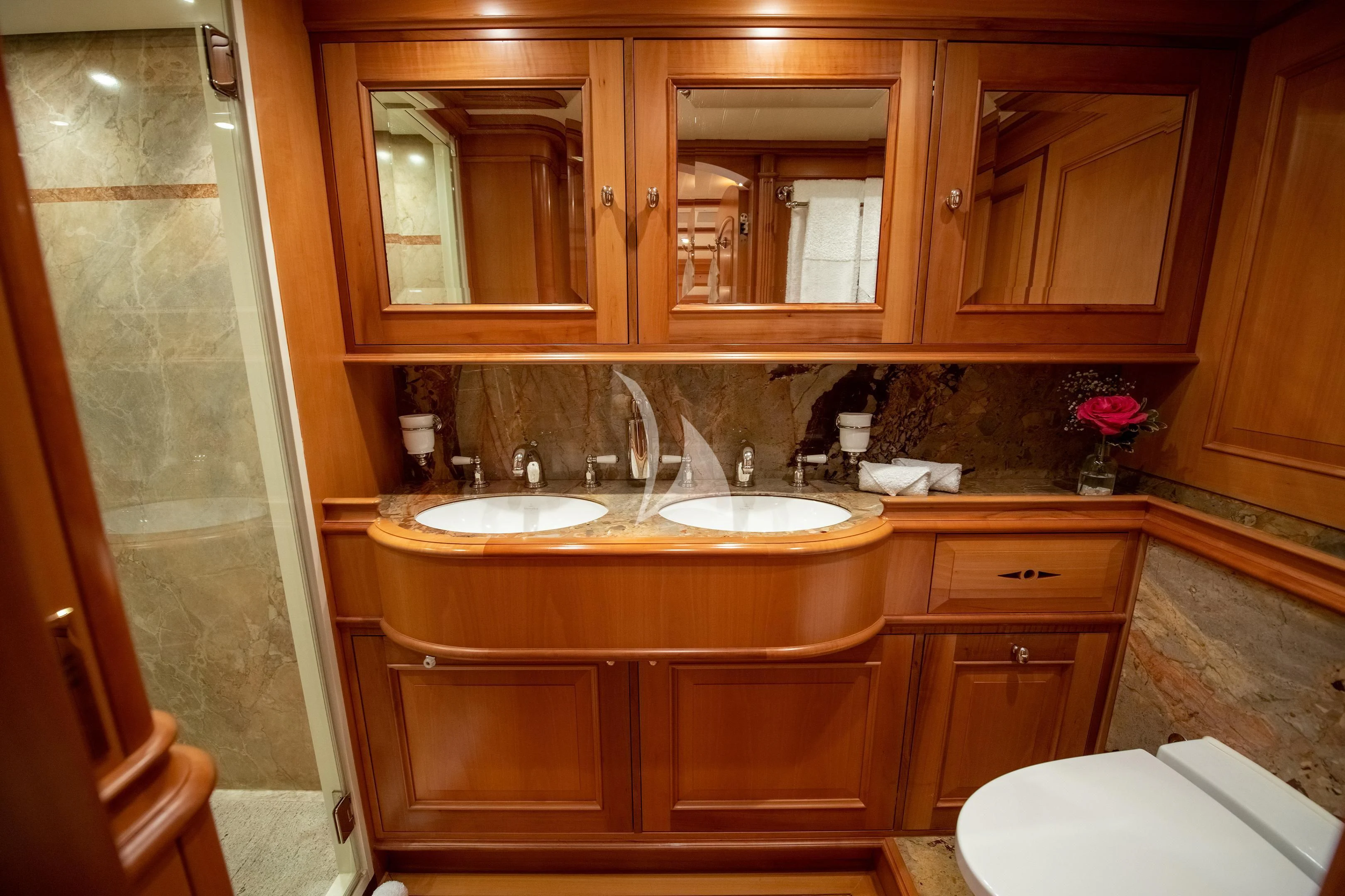 a bathroom with wooden cabinets aboard ATHOS Yacht for Sale