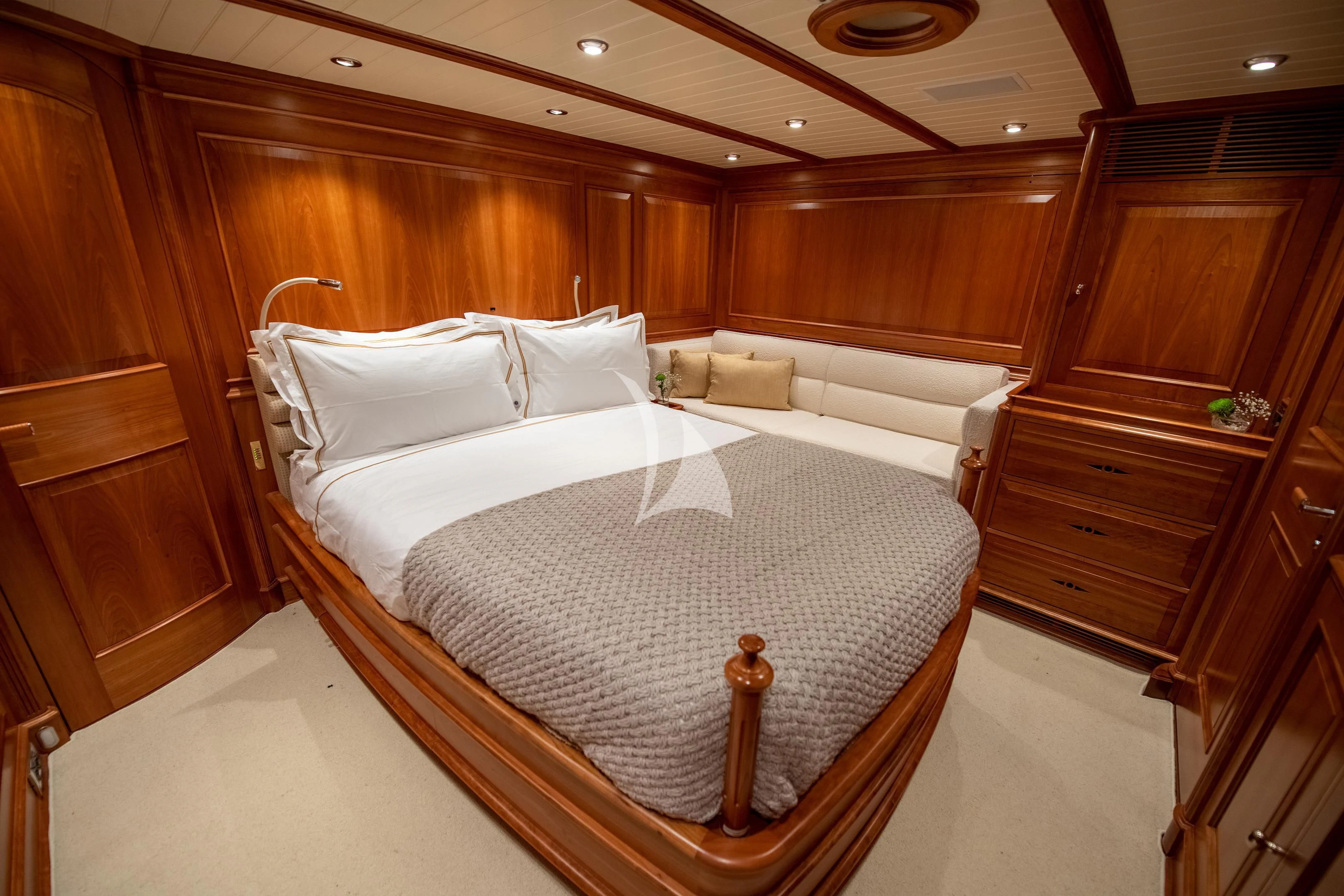 a room with a bed and a wood cabinet aboard ATHOS Yacht for Sale