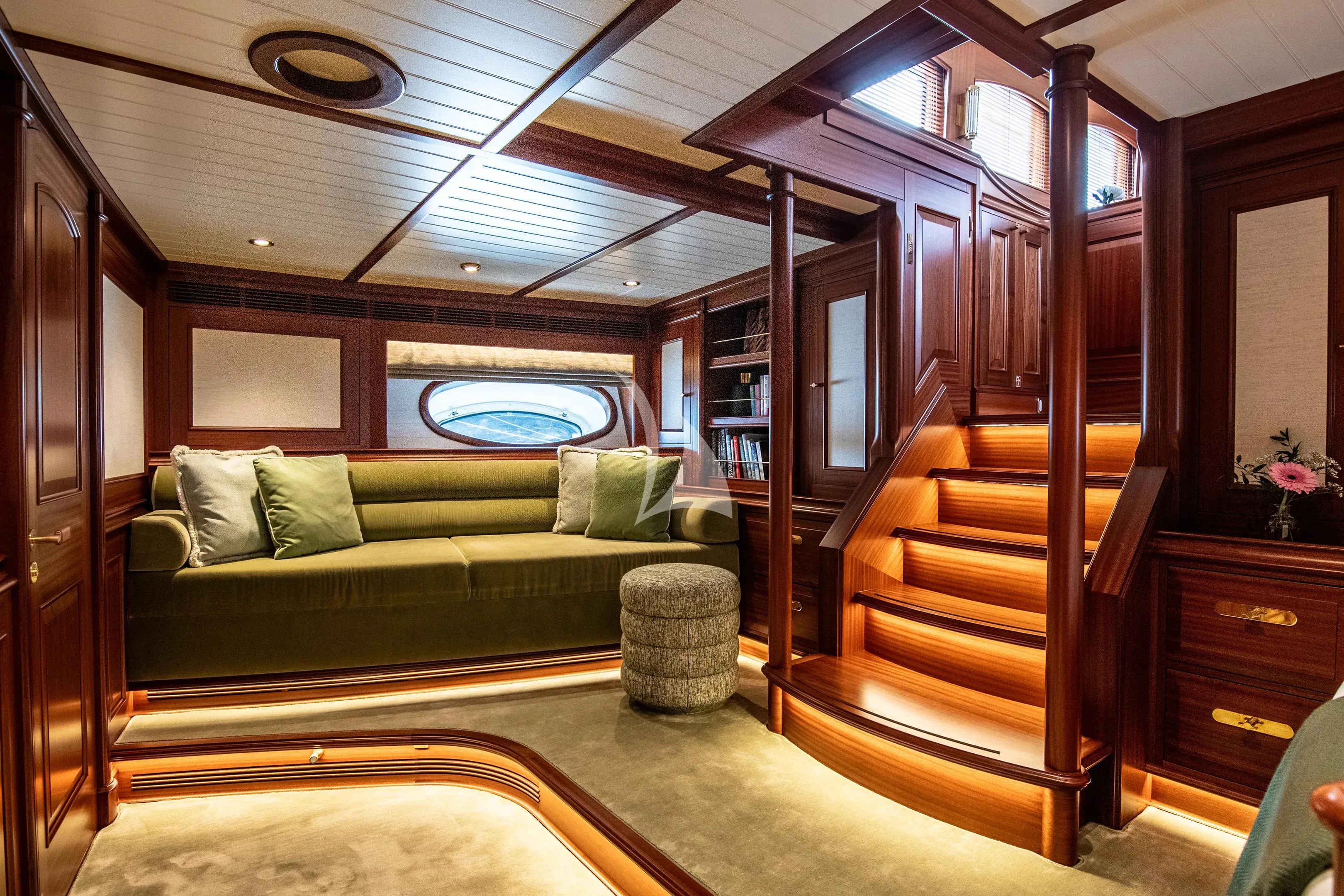 a room with a couch and a bed aboard ATHOS Yacht for Sale