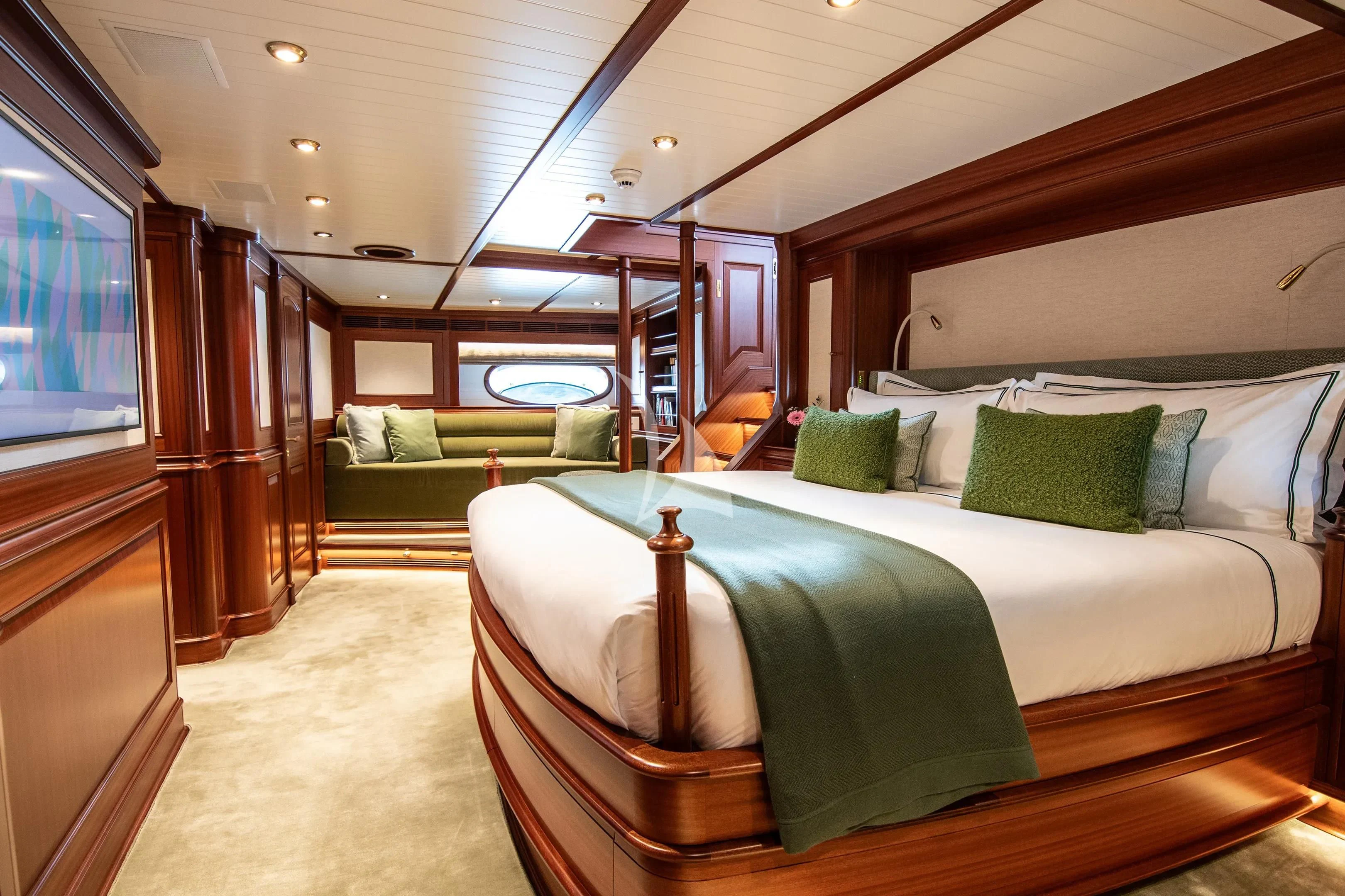 a room with a bed and a couch aboard ATHOS Yacht for Sale