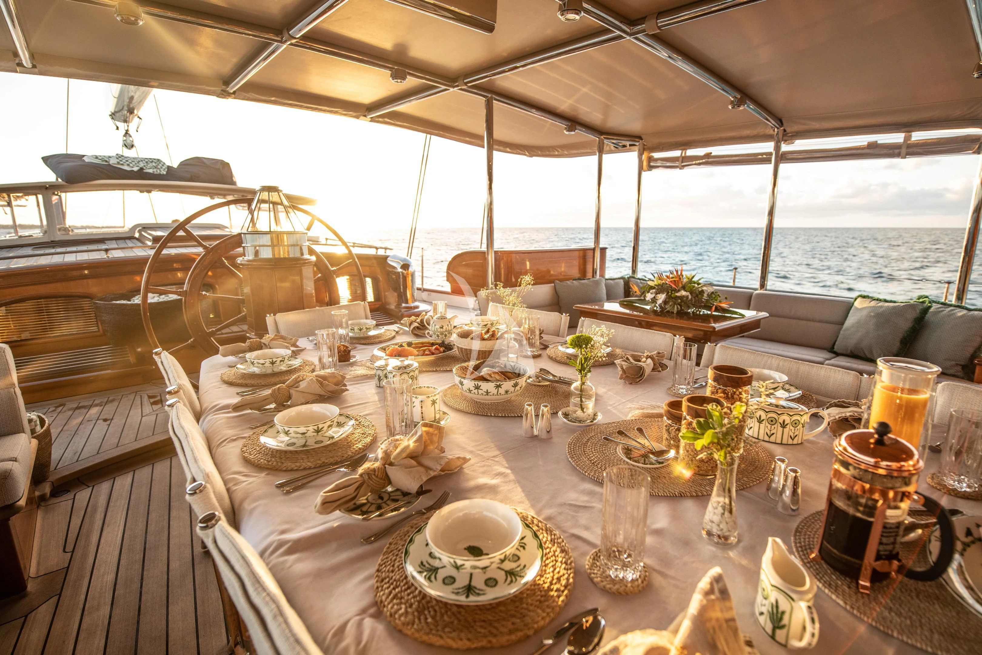 a table with plates and glasses on it aboard ATHOS Yacht for Sale